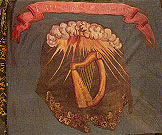 A green flag with a painted harp in the center. Above the harp is a painted image of sunlight bursting from a cloud.