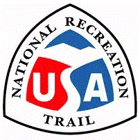 Rounded triangle-shaped logo with "National Recreation Area" around the border and a red, white, and blue "USA" with the "S" stylized as a trail leading to mountains