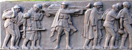 Relief on the St Annes on Sea War Memorial. Wounded men are led from the battlefield.