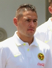 Player wearing white shirt, looking and focusing to their left.