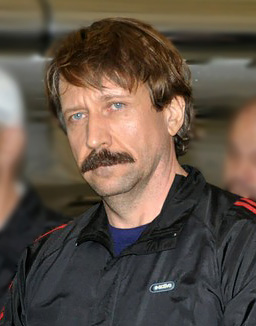 Image of Viktor Bout being escorted off a personal jet by agents of the Drug Enforcement Agency of the United States