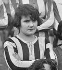 Carmen Pomiès, a white French woman with dark hair, in a striped shirt with arms crossed