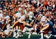 Photo of Mark Murphy in his uniform during the Super Bowl tackling a Miami Dolphins player