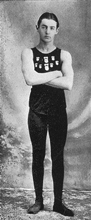 Young AC Gilbert in a sleevless tank top, standing