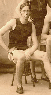 Walter Tewksbury seated on a stool wearing his University of Pennsylvania athletic jersey