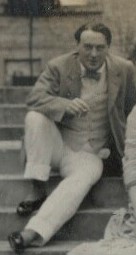 Photo of Desmond MacCarthy in 1912, seated on steps