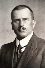 A black and white portrait of Carl Gustav Jung.