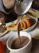 Hot chocolate served with a croissant