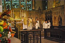 A priest stands at the right side of the altar to pray the Introit.