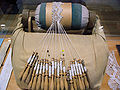 Bobbin lace made on a pillow with bobbins and pins