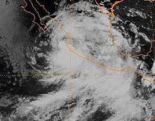 A satellite image of a large tropical depression near Mexico, with thicker clouds in the south-central portion of its circulation