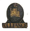 Embossed sheet brass British fire plaque with black painted details. (Flat sheet metal emblems may be called fire plaques.)