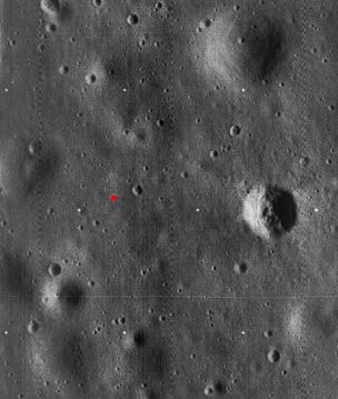 High-resolution Lunar Orbiter 5 image cropped to show the landing site of Apollo 11. The landing site is indicated by a red dot. The prominent crater at right is called West crater and is about 190 m in diameter.
