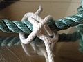 C : Complete the overhand knot with the main line under both riding turns, entering from left