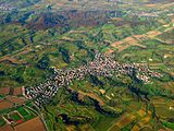 Aerial panorama of Malterdingen illustrates the hilly and forested terrain surrounding the village.