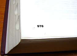 The bottom left corner of a page in a large book; the number "978" appears.