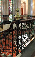 Pineapple finial atop corner post of an ornate metal stair railing, Town Hall, Birkenhead, England