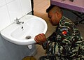Soldier fixes a sink