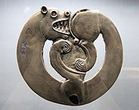 Curled-up feline animal from Arzhan-1, circa 800 BCE.[15][16] This is the earliest known of a common animal art design.