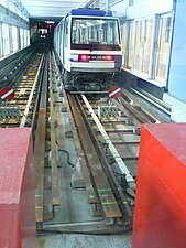 Lausanne Métro Line M2, showing the angle iron guide bars and the I-beam roll ways as well as bumper posts