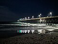 Surf City Pier at night, showing people fishing at night