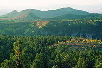 Forested mesa tops are framed by the San Miguel Mountains in the Bandelier Wilderness