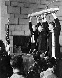 William Hayward Pickering, James Van Allen, and Wernher von Braun display a full-scale model of Explorer 1 at a crowded news conference in Washington, D.C. after confirmation the satellite was in orbit.