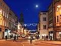 Night view of the High Street with Christmas lights, looking east from Carfax.