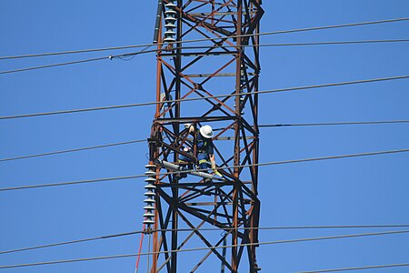 A line worker on a tower