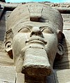 A close-up of one of the colossal statues of Ramesses II wearing the double crown of Lower and Upper Egypt