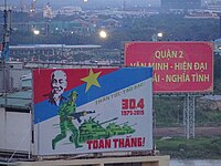 A large road sign in Ho Chi Minh City, Vietnam, commemorating the 30th April 1975. The pictures bears the declaration of a total victory.