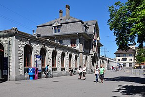 Forecourt and three-story railway station building with wings either side