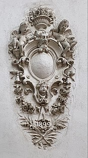 Arabesque with a big and blank cartouche and cherubs, on a wall of Intrarea Costache Negri no. 1, Bucharest, unknown architect, 1899