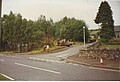 A picture Balnain in 1998. The Shelter by the workmen is the new 1990's bus shelter and the white concrete shelter behind the van is the old 1970's bus shelter.