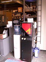 A machine (right) and water cooler at a work environment