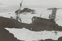 Sanct Svithun beached and sinking after 30 September attack.