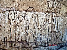 Shoshenq III, standing on the boat "msktt", the boat of the night, with the god Atum. From his tomb in Tanis.