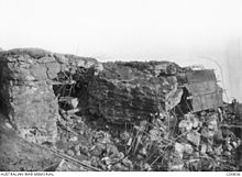 A black and white photograph of damaged masonry