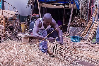 Craftsman weaving a basket made from split rattan in Nigeria