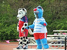 Two costumed team mascots; the Chicago Fire mascot is a Dalmatian dog.