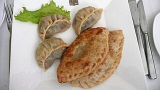 Two kinds of dumplings: Buuz (top left) and Khuushuur (lower right)