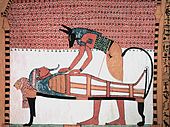 Picture of the wall painting from the tomb of Sennedjem in which Anubis attends the mummy of the deceased