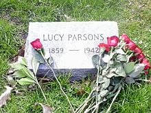 Red roses on simple headstone which reads LUCY PARSONS 1859–1942