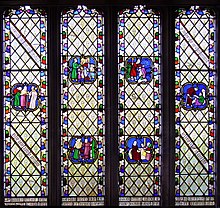Photo of colourful stained class window showing human figures
