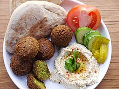 Palestinian breakfast with falafel, hummus, torshi and khubz bread