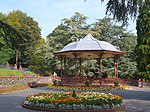 a bandstand and flower beds in a park