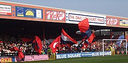 One of the stands of the Bootham Crescent association football ground, with supporters waving flags