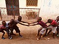 Children engaging in traditional Tug of War game