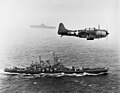 An SBD Dauntless flies patrol over USS Washington and USS Lexington during the Marshall islands campaign.