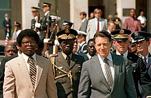 President Samuel Doe walks with U.S. Secretary of Defense Caspar Weinberger during a visit to Washington DC in 1982